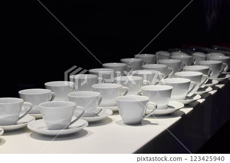 An Elegant Display of White Tea Cups Beautifully Arranged on a Chic and Stylish Table An Elegant Display of White Tea Cups Beautifully Arranged on a Chic and Stylish Table 123425940