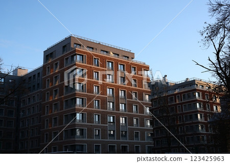 A Modern Urban Residential Complex Nestled Below a Clear Blue Sky on a Bright Day 123425963