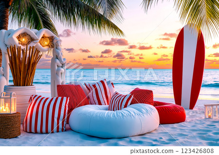 A beach scene with red and white pillows and a surfboard on the sand 123426808