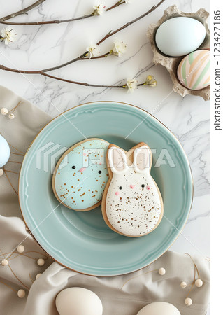 Beautiful easter table setting featuring pastel plates and bunny cookies on marble background Beautiful easter table setting featuring pastel plates and bunny cookies on marble background 123427186