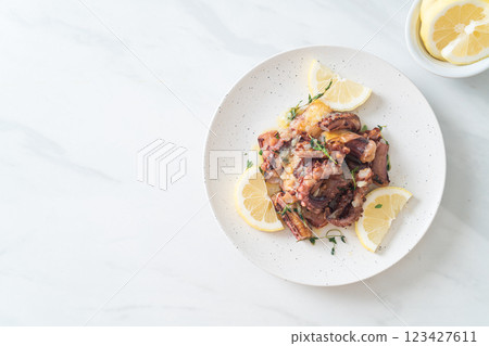 grilled octopus or squid with butter lemon sauce grilled octopus or squid with butter lemon sauce 123427611