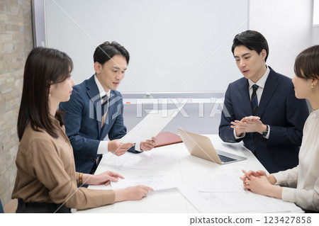 A meeting of several male and female businessmen, examining documents and thinking about them A meeting of several male and female businessmen, examining documents and thinking about them 123427858