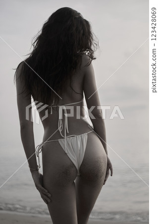Beautiful body woman on the beach. Sexy back of girl in Bikini. Monochrome silhouette Beautiful body woman on the beach. Sexy back of girl in Bikini. Monochrome silhouette 123428069