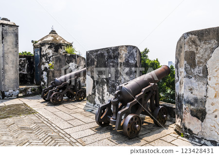 Replica cannon and defense wall of Mount Fortress, Fortaleza do Monte is located in Santo Antonio in Macau. The fort is one of the UNESCO World Heritage. Replica cannon and defense wall of Mount Fortress, Fortaleza do Monte is located in Santo Antonio in Macau. The fort is one of the UNESCO World Heritage. 123428431