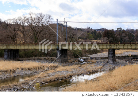 Scenery of a local train crossing an iron bridge Scenery of a local train crossing an iron bridge 123428573