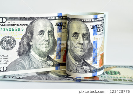 American dollars with the portrait of the president rolled into rolls and more. 123428776