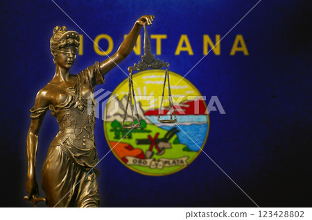 Lady Justice before a flag of Montana 123428802