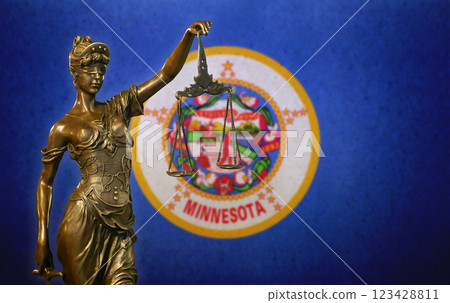 Lady Justice before a flag of Minnesota 123428811