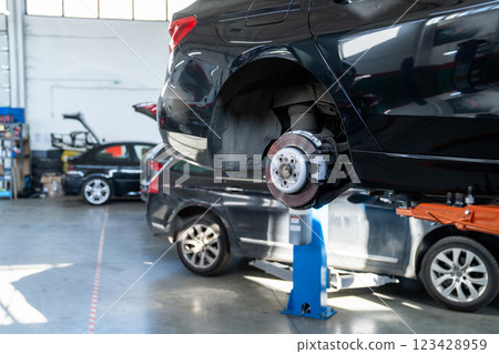 Car service workshop with cars on a column lifts 123428959