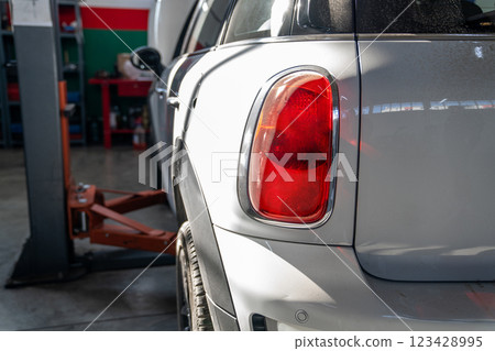 Car service workshop with cars on a column lifts 123428995