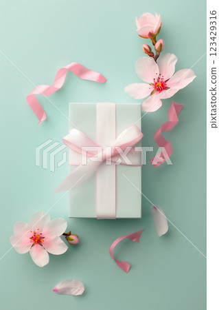 Spring gift box with pink bow and flowers on pastel green background for sale promotion Spring gift box with pink bow and flowers on pastel green background for sale promotion 123429316
