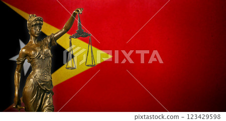 Lady Justice before a flag of East Timor Lady Justice before a flag of East Timor 123429598