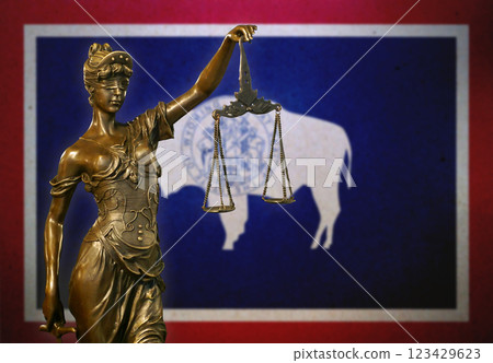 Lady Justice before a flag of Wyoming Lady Justice before a flag of Wyoming 123429623