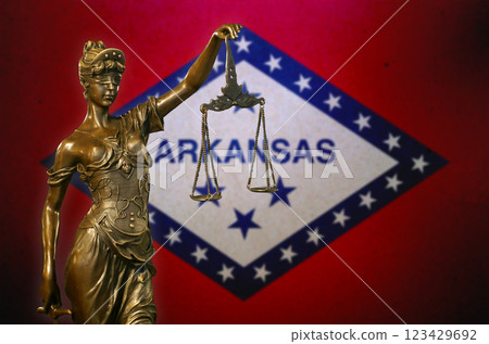 Lady Justice before a flag of Arkansas Lady Justice before a flag of Arkansas 123429692