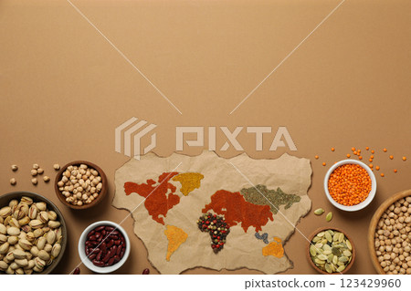 Map, spices, seeds and beans on beige background, space for text 123429960