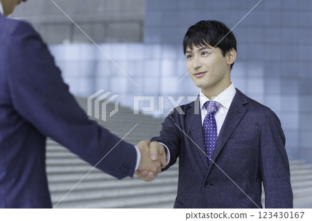 Portrait of two young businessmen shaking hands 123430167