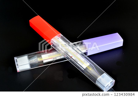 Two mercury thermometers for measuring human body temperature. 123430984