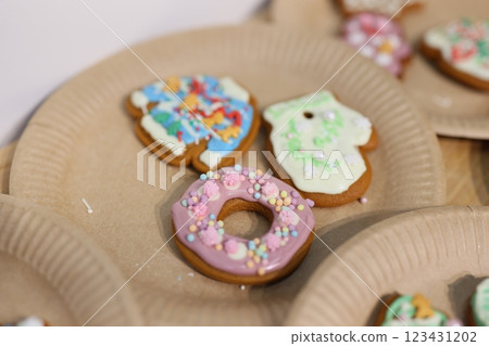 Vibrantly Colorful Decorated Cookies Displayed on Festive Paper Plates for Everyone to Enjoy 123431202