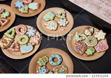 Beautifully Festively Decorated Holiday Cookies Served on Colorful Plates for Enjoyment 123431204