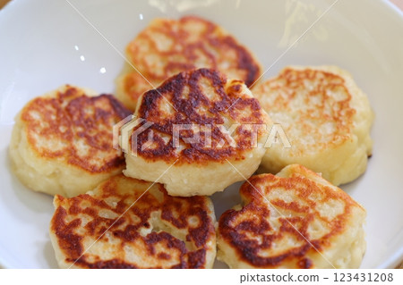 Deliciously made Golden Potato Pancakes beautifully arranged on a pristine White Plate Deliciously made Golden Potato Pancakes beautifully arranged on a pristine White Plate 123431208