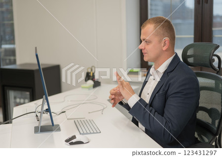 Caucasian deaf man uses sign language for online negotiations. 123431297