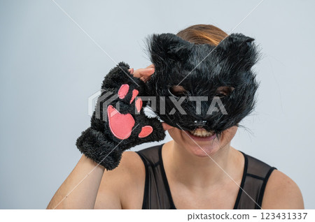 Portrait of a woman in a cat costume on a white background. Quadrober. Portrait of a woman in a cat costume on a white background. Quadrober. 123431337