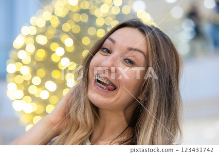 Portrait of a grimacing woman with braces on her teeth. Portrait of a grimacing woman with braces on her teeth. 123431742