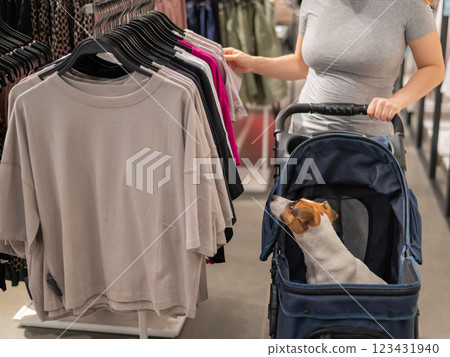 Caucasian woman shopping with pet in mall. Dog in a carrier. Caucasian woman shopping with pet in mall. Dog in a carrier. 123431940