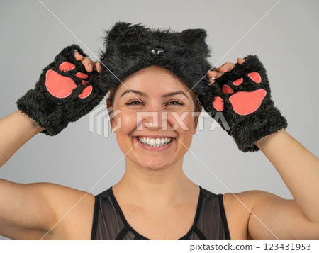 Portrait of a woman in a cat costume on a white background. Quadrober.  123431953