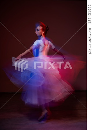 Caucasian woman dancing classical dance in tutu . Long exposure photo.  123431962
