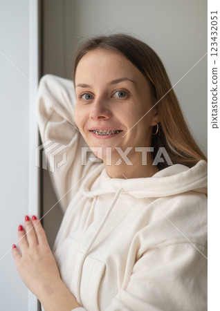 Woman smiling with braces on her teeth.  123432051