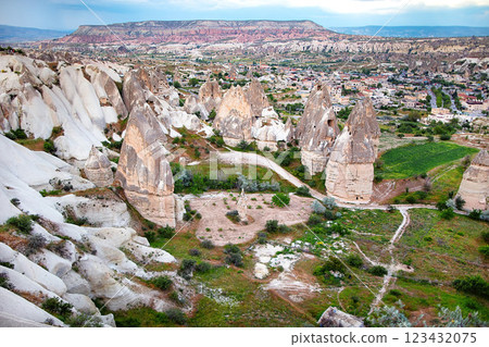 Majestic rock formations rise above the enchanting landscape of Cappadocia at sunset. Majestic rock formations rise above the enchanting landscape of Cappadocia at sunset. 123432075