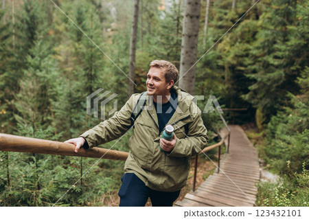 Young man hiking in nature. Travel, adventure. Concept of an active lifestyle. The National park Adrspach Teplice rocks. High quality photo. 123432101
