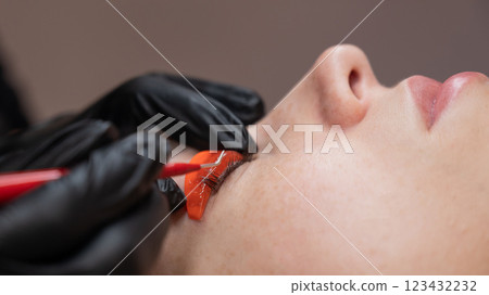 Caucasian woman undergoing eyelash lamination procedure. Caucasian woman undergoing eyelash lamination procedure. 123432232