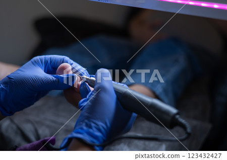 Pregnant woman on a hardware pedicure procedure in a beauty salon.  123432427