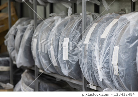 New car tires in plastic bags in a store.  123432494