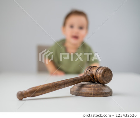 Little boy behind judge's gavel.  123432526