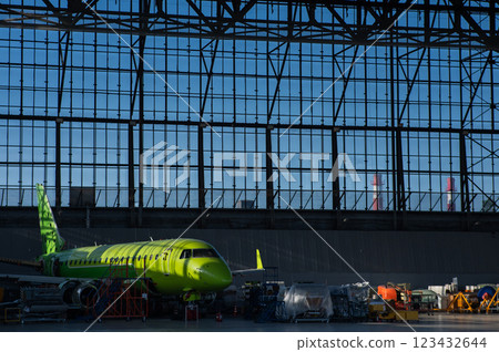 Airplane undergoing repairs in a hangar. Airplane undergoing repairs in a hangar. 123432644