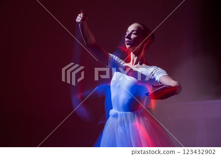 Caucasian woman dancing classical dance in tutu . Long exposure photo. Caucasian woman dancing classical dance in tutu . Long exposure photo. 123432902