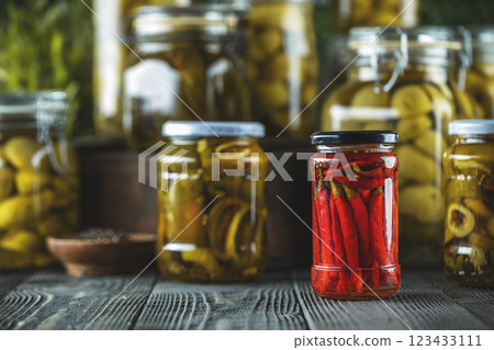 Jars of pickled red chili peppers Jars of pickled red chili peppers 123433111
