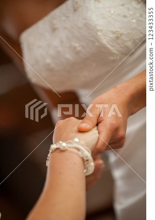 A Beautiful Engaged Couple Holding Hands Together During Their Wedding Ceremony Celebration A Beautiful Engaged Couple Holding Hands Together During Their Wedding Ceremony Celebration 123433355