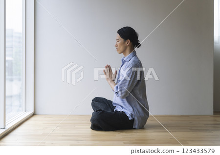 A man in his 40s meditating 123433579