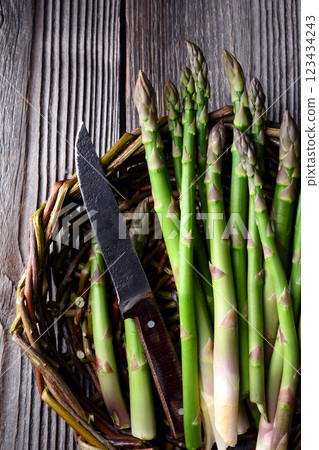 Fresh asparagus spears tied with knife 123434243