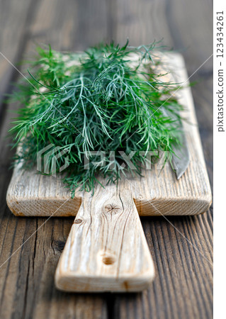 Freshly washed dill on wooden cutting board 123434261