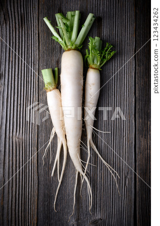 Top view of white daikon radish with roots 123434262