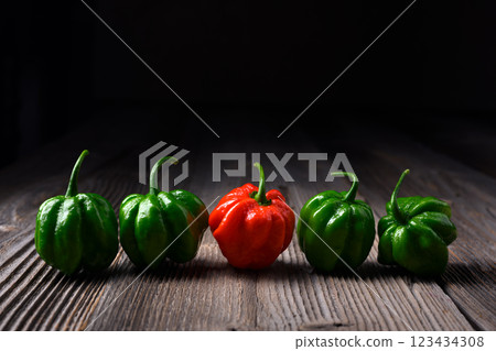 Green and red habanero peppers placed in a row 123434308