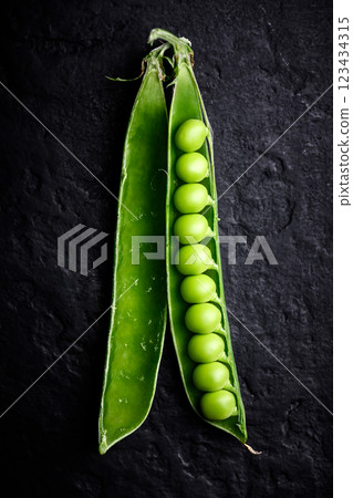 Green sugar snap pea pod with kernels in a row Green sugar snap pea pod with kernels in a row 123434315