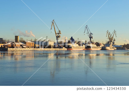 Moored ship and harbour cranes in port on Neva river 123434330