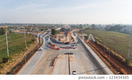 Drone shot aerial view of high angle view of a construction site building intersection across the bridge 123434385
