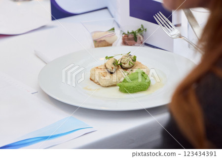 Delicious Cuisine Plate with Fish and Green Puree at a Sophisticated Dining Event 123434391